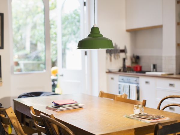 green-pendant-light-hanging-over-dining-table-970432610-5c53b49b4cedfd0001efd8f4.jpg